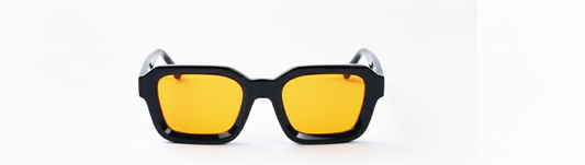 Sunglasses with black frame and yellow lenses on a white background